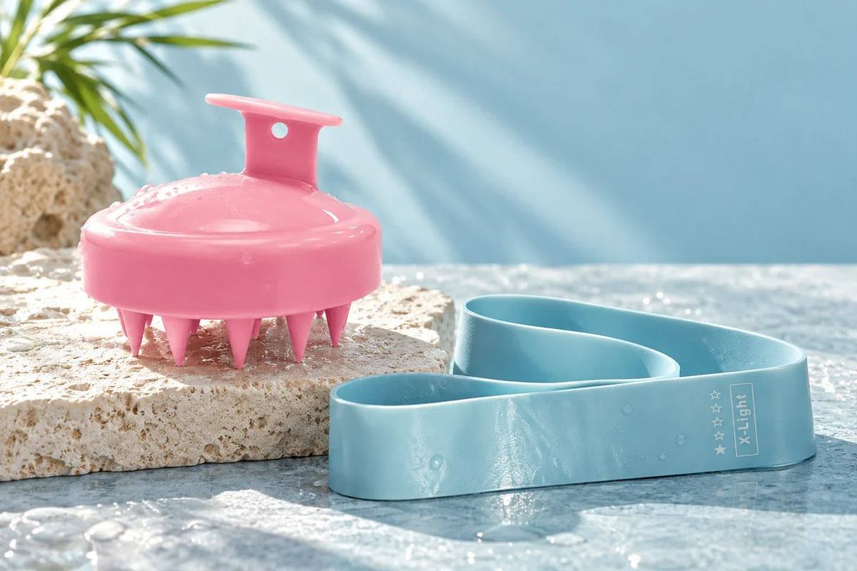 Pink scalp brush and blue resistance band; products sold separately