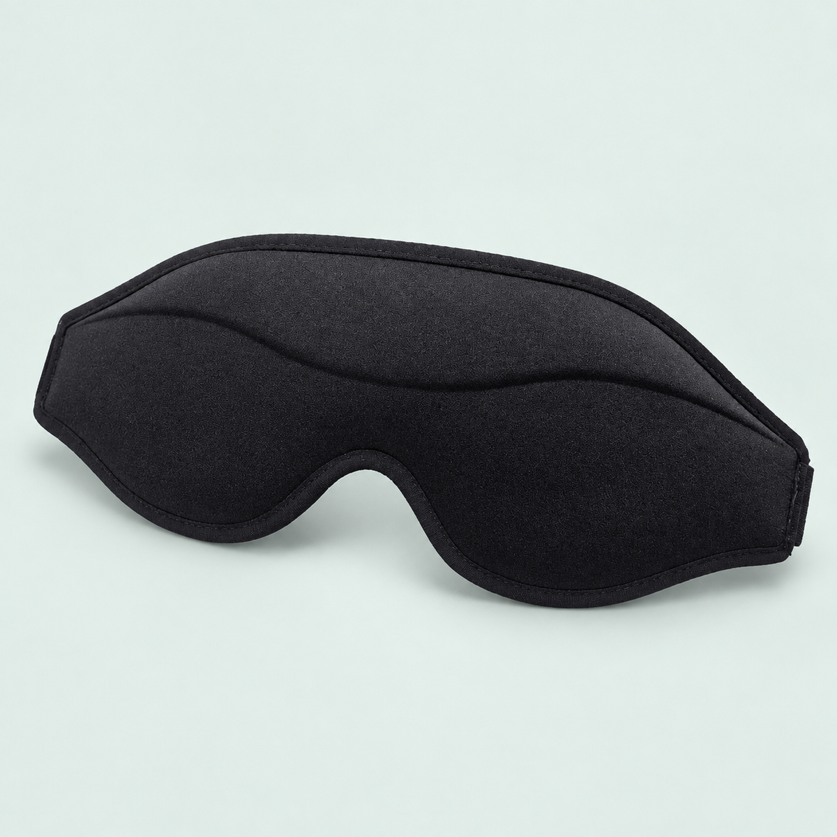 Contoured memory-foam eye mask — representative option in a coastal studio setting; choose options for exact contents.